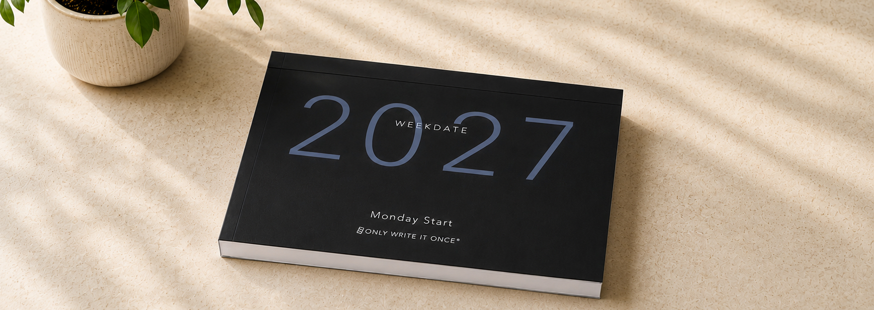 WeekDate 2027 dated paper planner on a desk